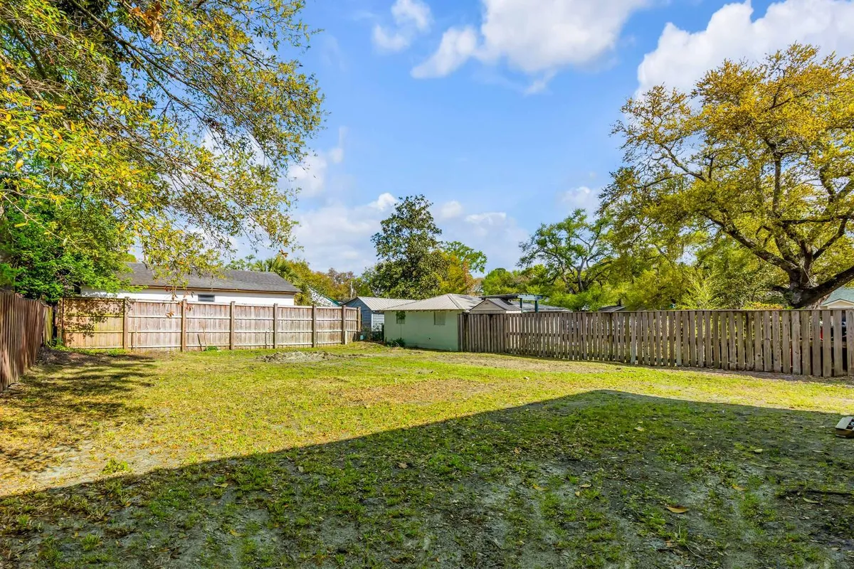 An expansive, fenced lawn bordered by mature trees sets a relaxing scene ideal for gathering with friends, hosting outdoor barbecues, or unwinding after a night out. The open space is inviting and versatile, suggesting group-friendly activities both at home and within the community.