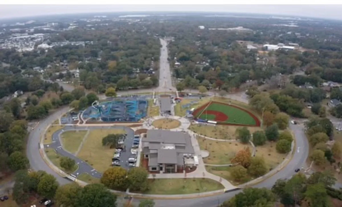 This image shows a vibrant community hub with a community center, playground, baseball field, and tree-lined streets. It captures the lively energy of the neighborhood, highlighting recreational opportunities and the social atmosphere.
