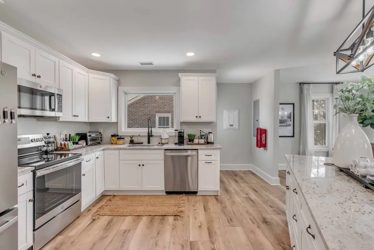A welcoming kitchen scene showcasing stainless steel appliances, granite countertops, and a spacious kitchen island. The layout promotes gathering, meal prep, and social interaction, with warm, ambient lighting that makes the space feel inviting.