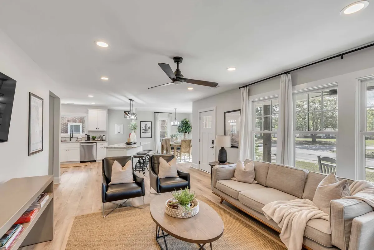 The hero image showcases a bright, cozy living and dining area with inviting, comfortable seating, a stylish dining table perfect for family meals or gatherings, and large windows that flood the space with natural light. The interior exudes warmth and elegance, creating a welcoming atmosphere ideal for relaxing or socializing with loved ones.